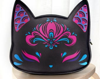 May include: Black faux leather purse shaped like a cat's face with pink and blue floral designs and a zipper closure.