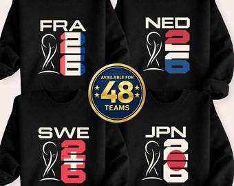 May include: Black sweatshirts with country abbreviations and flag-inspired designs. The sweatshirts feature the text "FRA", "NED", "SWE", and "JPN", along with the number "2016" and a graphic. A gold emblem reads "AVAILABLE FOR 48 TEAMS".