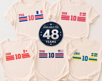 May include: Cream-colored t-shirts with country flag designs and the number 10. Flags include France, Denmark, Canada, USA, and Sweden. A circular emblem reads "AVAILABLE FOR 48 TEAMS".