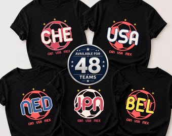 May include: Black t-shirts with soccer ball graphics. Each shirt features a different three-letter team abbreviation: CHE, USA, NED, JPN, and BEL. The text "CAN USA MEX" is below each graphic. A central graphic states "AVAILABLE FOR 48 TEAMS".