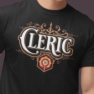 May include: Black t-shirt with a gold and white design that says "CLERIC" with a stylized symbol of a sun and a staff.