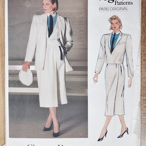 May include: Vogue Patterns Paris Original sewing pattern featuring a Christian Dior design. The pattern includes a white suit with a skirt, a blazer, and a blue shirt with a black tie. The pattern number is 1447.