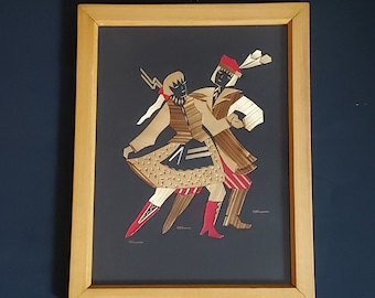 May include: A framed straw art piece depicting two figures in traditional folk costumes, dancing. The figures are silhouetted in black and have red accents. The background is a dark gray.