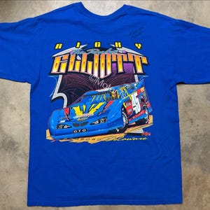 May include: Royal blue t-shirt with a race car graphic. The design features the words "Ricky Righth" in yellow and white, and the race car has the number 45. The text "GTO" and "Seaford Delaware" are also visible.