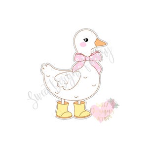 May include: A white goose with a pink bow and yellow rain boots. The goose is wearing a pink bow with white polka dots. The goose is standing on a white background.