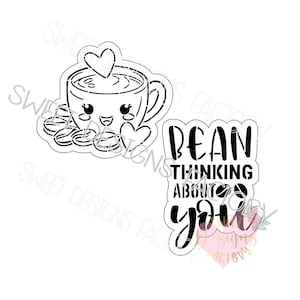 May include: Black and white cookie cutter design of a coffee cup with a heart and the text "Bean thinking about you".