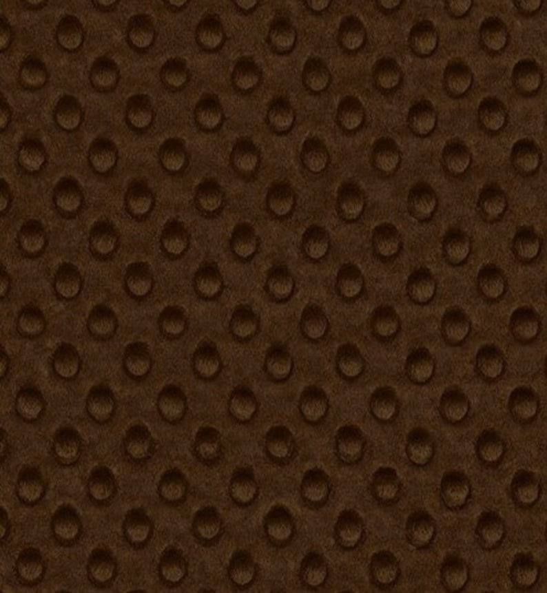 May include: Brown fabric with a textured pattern of small, raised circles.