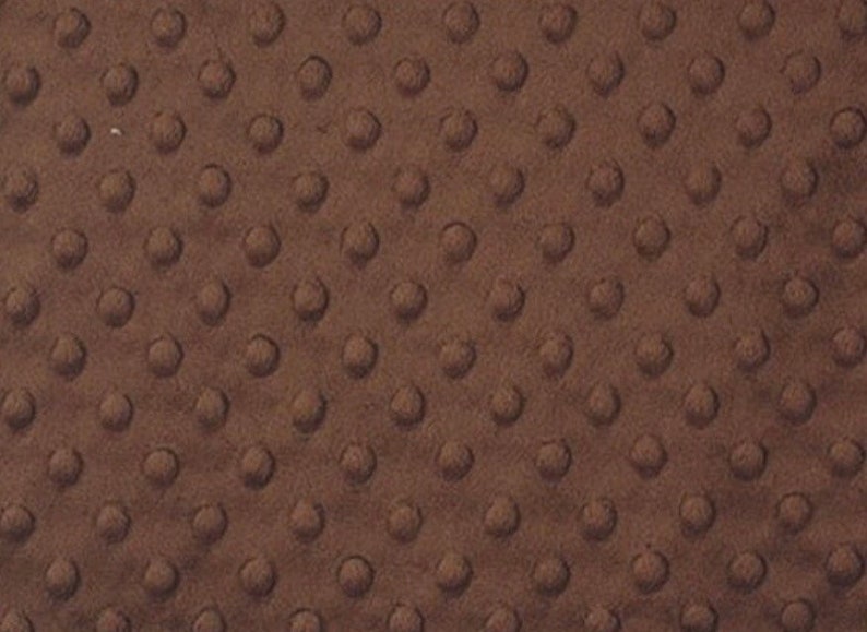 May include: A close-up of a brown minky fabric with a textured dot pattern.