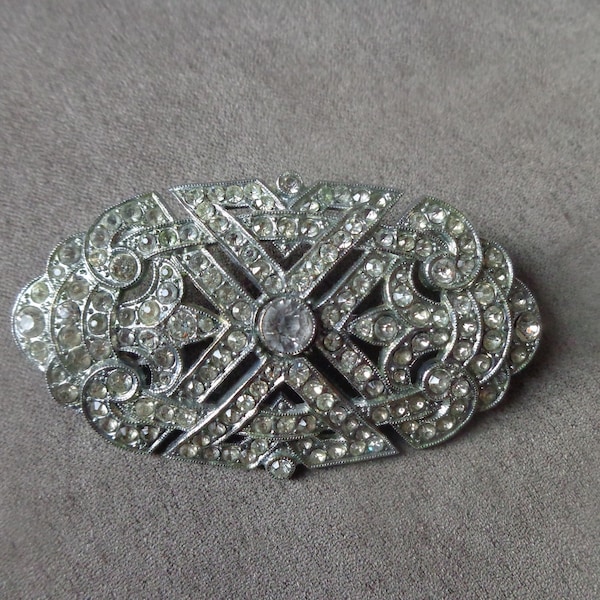 Silver tone oval brooch pave set with clear rhinestone and with trombone catch