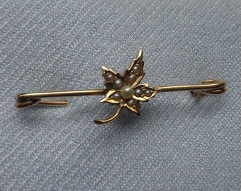 14 Karat gold safety pin type brooch with seed pearls