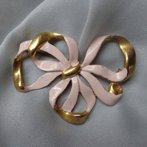 Gilded and enameled pink bow brooch