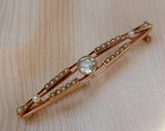 Edwardian 14K gold bar brooch with seed pearls and light blue gemstone.