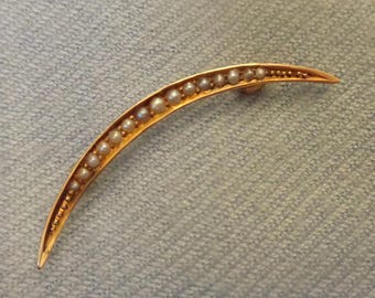 Gold crescent brooch with seed pearls