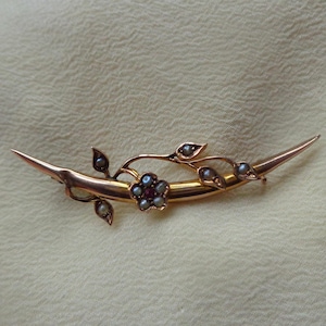 Gold honeymoon crescent brooch with seed pearls and red gemstone