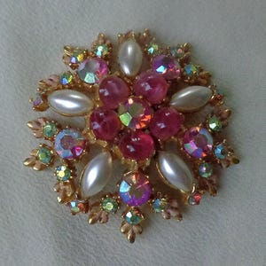 Gold tone brooch with marbleized pink cabochons, faux pearls and AB rhinestones