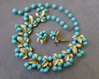 KRAMER floral bib necklace and earrings with faux turquoise beads and gold tone leaves