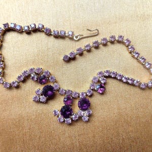 Gold tone necklace with purple and lavender rhinestones