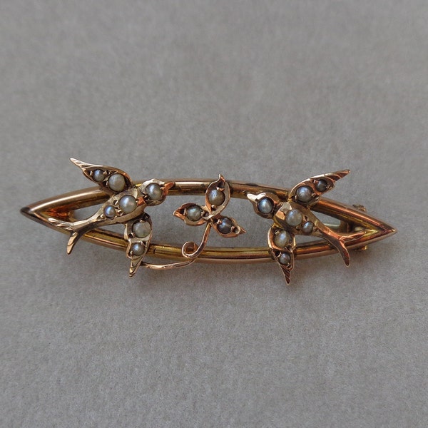 Edwardian gold brooch with swallows and ivy leaf ornamented with natural seed pearls