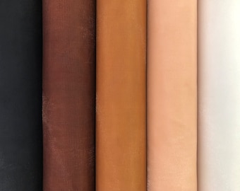 May include: Six rolls of fabric in different shades of brown, from dark brown to light beige.