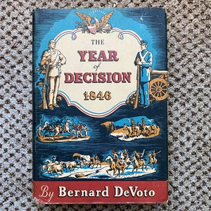 May include: A vintage book titled "The Year of Decision 1846" by Bernard DeVoto. The cover features illustrations of historical figures, battles, and a bald eagle emblem. The color palette includes blue, red, and cream.