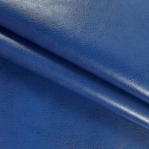 May include: Close-up of a blue faux leather fabric with a textured surface.
