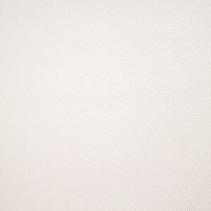 May include: A close-up of a white textured surface. The surface has a subtle, grainy texture.