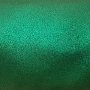May include: A close-up of a textured, green leather surface.