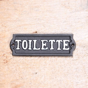 black and white french language bathroom toilet plate