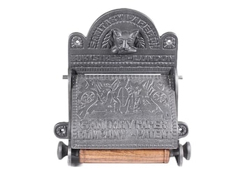 May include: A cast iron toilet paper holder with an ornate design. It features a cat head with wings and the text "SANITARY PAPER COMPANY PATENT" and "BURY STREET LONDON".