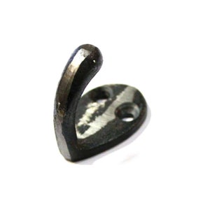 May include: A dark grey, hand-forged metal hook with a curved design. The hook has a rounded end and a flat, oval base with two holes for mounting. The metal has a textured, slightly rough appearance, suggesting a rustic or industrial style.
