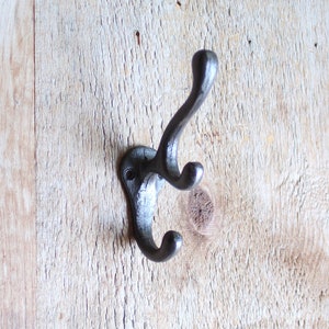 Triple Cast Iron Coat, jacket, or hat hook.