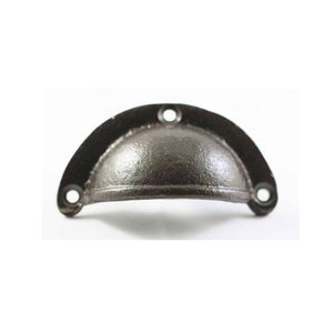 May include: A black cast iron drawer pull with a rounded, domed shape. The pull has a smooth, slightly textured finish and two small holes on each side.