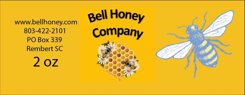 May include: A yellow label with the text "Bell Honey Company" and a bee illustration. The label also includes contact information: www.bellhoney.com, 803-422-2101, PO Box 339, Rembert SC. The label also includes the text "2 oz".