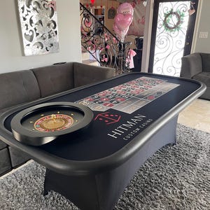 May include: Black felt roulette table with a roulette wheel, a felt layout with numbers 1-36, and the text "HITMAN CUSTOM CASINO".