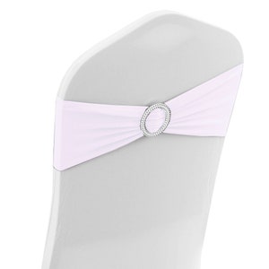 May include: White chair sash with a silver rhinestone buckle. The sash is tied in a bow around the back of the chair.