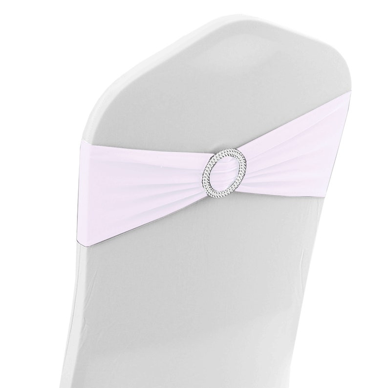 May include: White chair sash with a silver rhinestone buckle. The sash is tied in a bow around the back of the chair.
