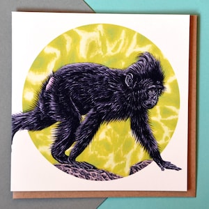 May include: A black and white illustration of a monkey walking on a yellow and white background. The monkey is in a circle.