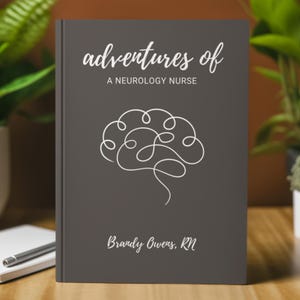 May include: A dark gray journal with the text "adventures of a neurology nurse" and a white line drawing of a brain. The journal is personalized with the name "Brandy Owens, RN".
