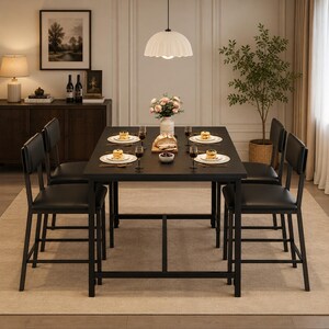 May include: A rectangular black dining table with four matching black chairs featuring padded seats and backrests. The table is set with four white plates, each holding a small stack of pancakes, along with wine glasses and a central floral centerpiece.