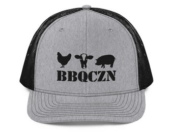 May include: A gray trucker hat with a black mesh back. The front of the hat features black silhouettes of a chicken, cow, and pig above the word "BBQCZN" in a bold, black font. The hat has a curved brim.