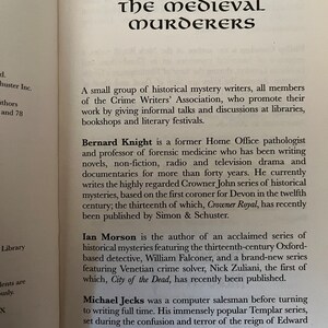 May include: An open book page displaying the title "The Medieval Murderers" in black, decorative font. The text describes historical mystery writers and their works, including Bernard Knight, Ian Morson, and Michael Jecks.