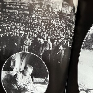May include: A black and white photograph from a book depicting a large crowd of people in front of a building, with banners in Cyrillic script. A circular inset shows a man seated at a desk. The image is a historical document.