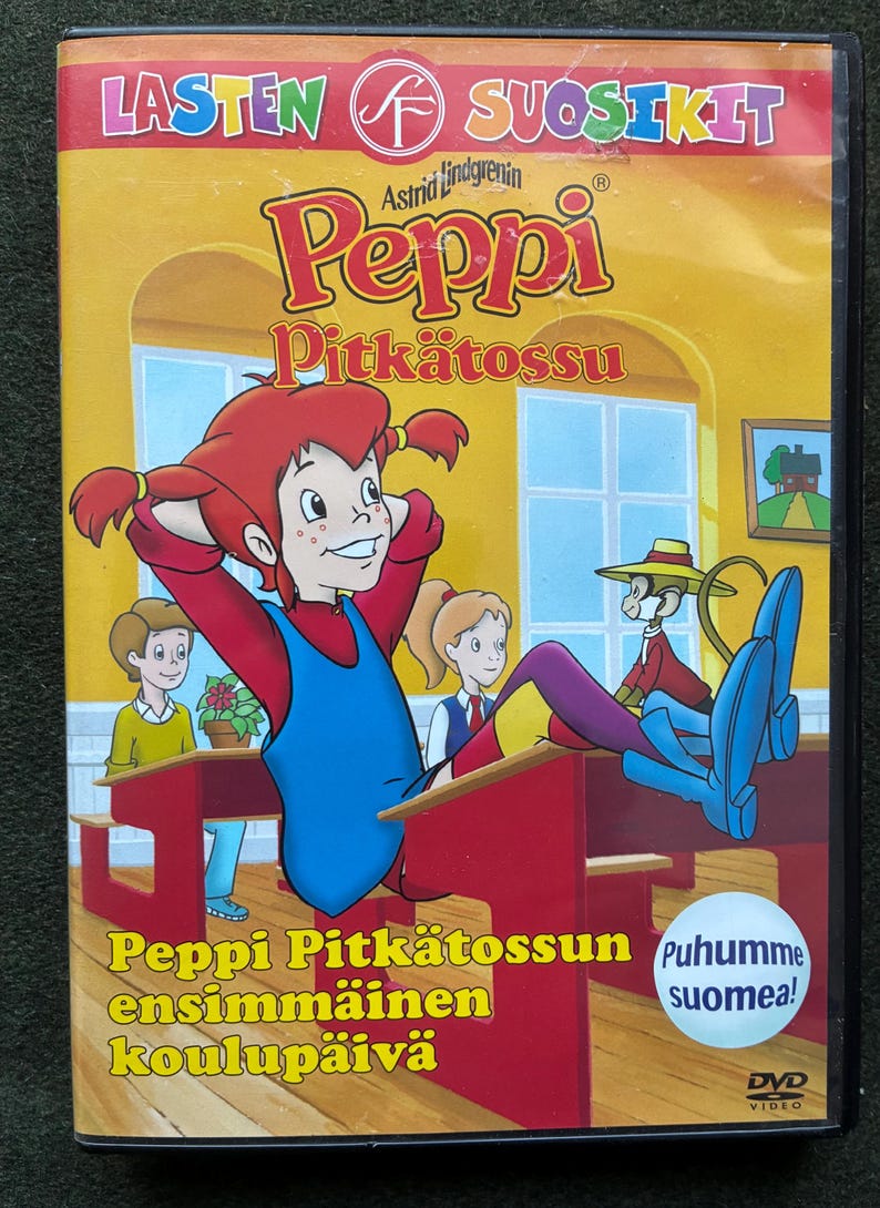 May include: DVD case featuring the animated character Peppi Pitk&auml;tossu, with text in Finnish. The cover art shows Peppi in a classroom setting, with other cartoon characters. The title "Peppi Pitk&auml;tossun ensimm&auml;inen koulup&auml;iv&auml;" is displayed.