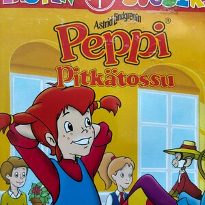 May include: A DVD case featuring the animated character Pippi Longstocking. The cover has a yellow background with the title "Peppi Pitk&auml;tossu" in red and yellow lettering. The image shows Pippi with red pigtails, a blue dress, and other cartoon characters.