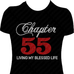 May include: Black t-shirt with a white rhinestone design that says "Chapter 55 Living My Blessed Life". The number 55 is in red rhinestones.