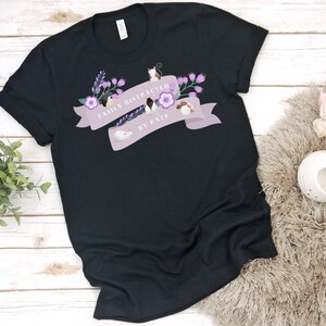 May include: Black t-shirt with a purple banner that says "Easily Distracted by Rats". The banner is decorated with flowers and small rats.