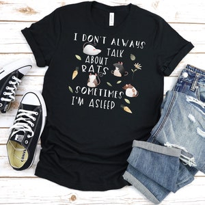 May include: Black t-shirt with a white graphic that says "I don't always talk about rats, sometimes I'm asleep". The graphic also features cartoon rats and carrots.