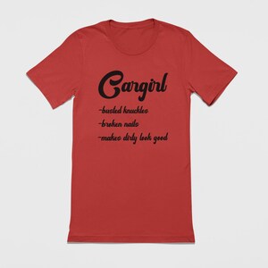 May include: Red t-shirt with black text that reads "Cargirl - busted knuckles - broken nails - makes dirty look good"