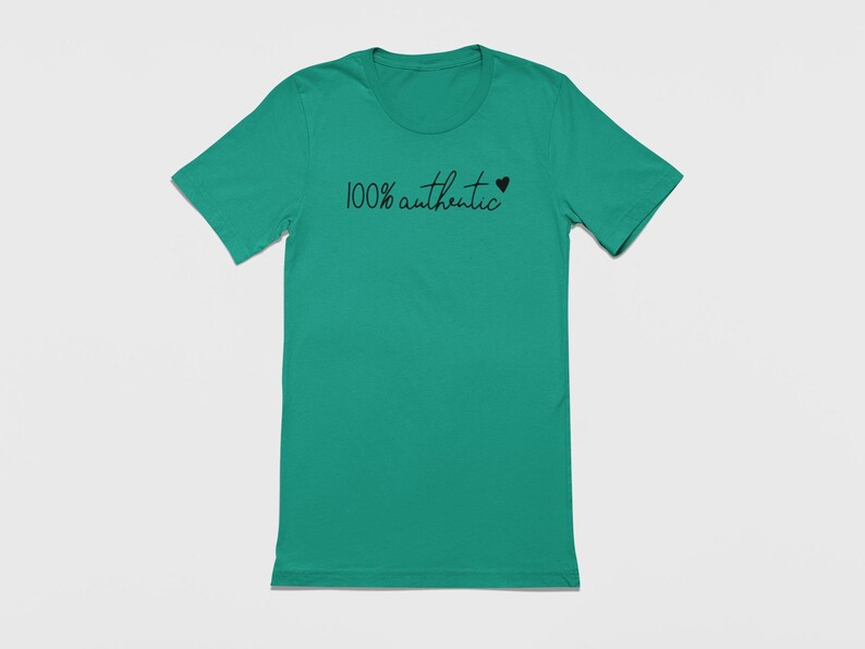 May include: A teal green t-shirt with the text "100% authentic" and a small black heart.
