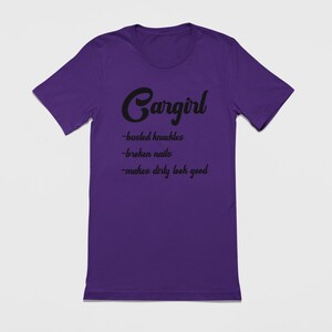 May include: Purple t-shirt with black text that reads "Cargirl -bucked knuckles -broken nails -makes dirty look good"
